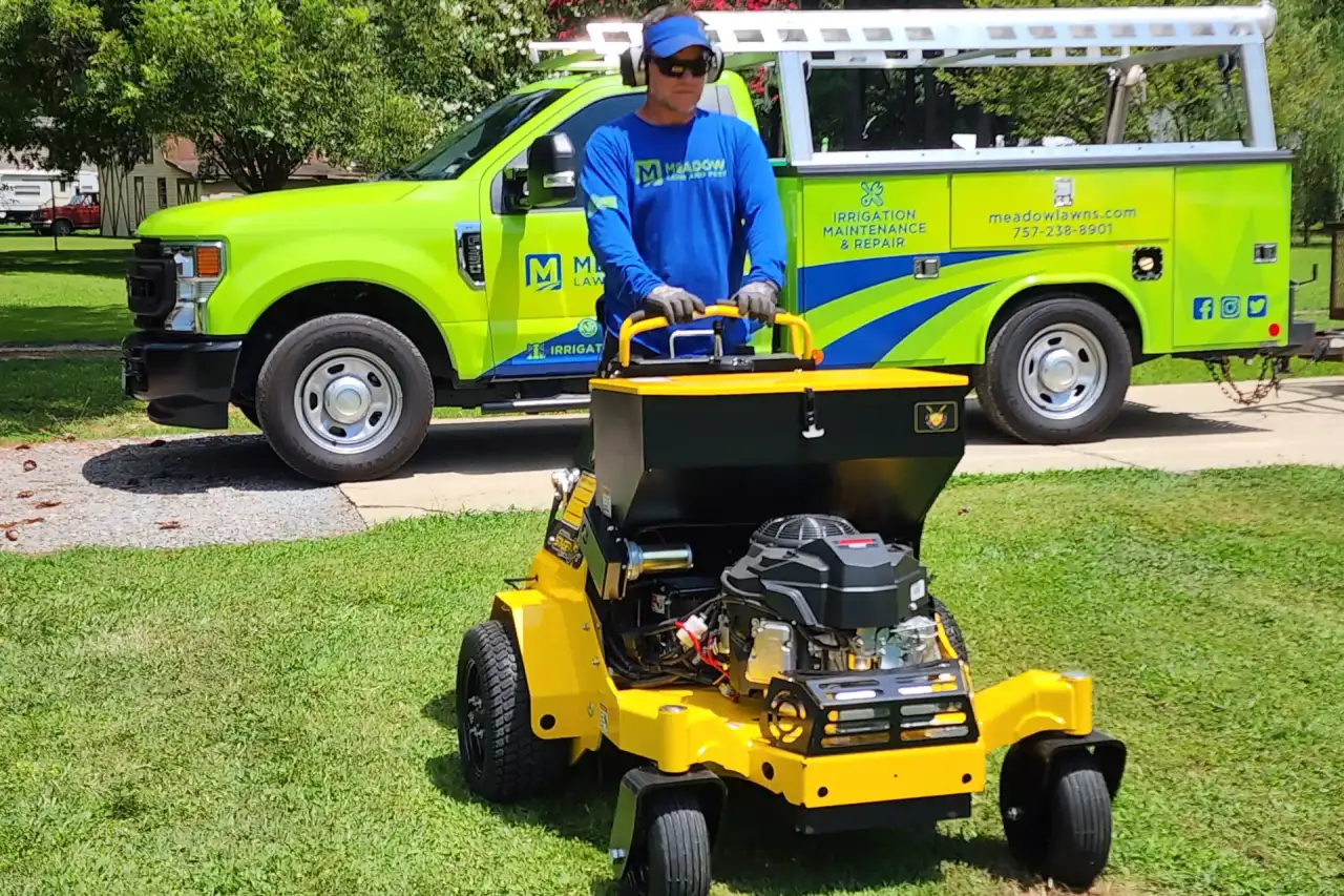 Lawn aerator working on a Hampton Roads lawn