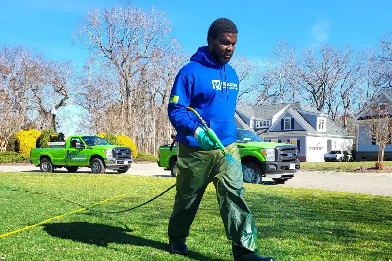 Hampton Roads lawn during weed control treatment showing the kind of post-emergent work Meadow Lawn & Pest delivers across Carrollton, Smithfield, and Suffolk properties
