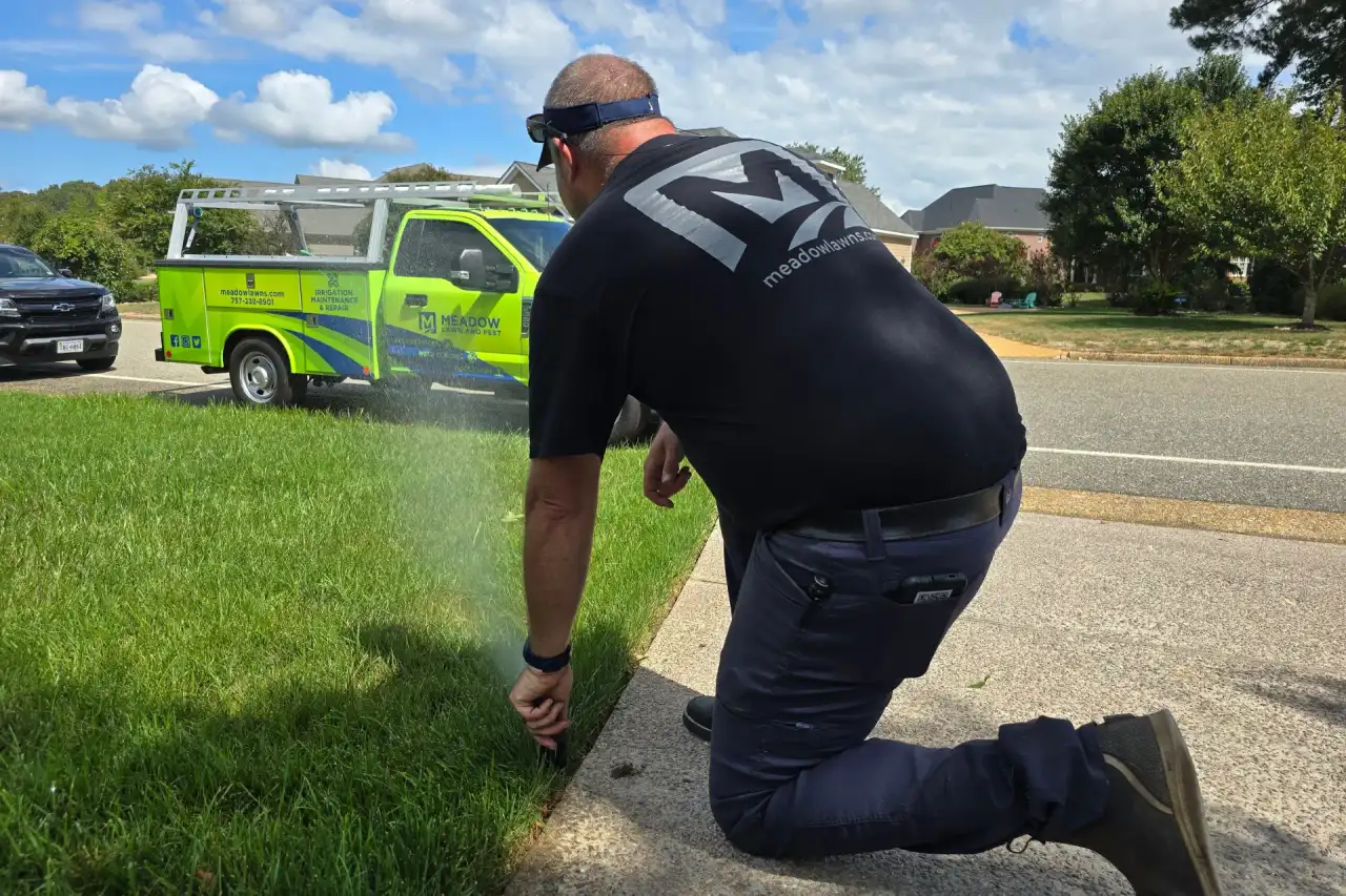 Hampton Roads lawn sprinkler running during early morning irrigation showing the kind of watering schedule Meadow Lawn & Pest recommends across Carrollton, Smithfield, and Suffolk properties